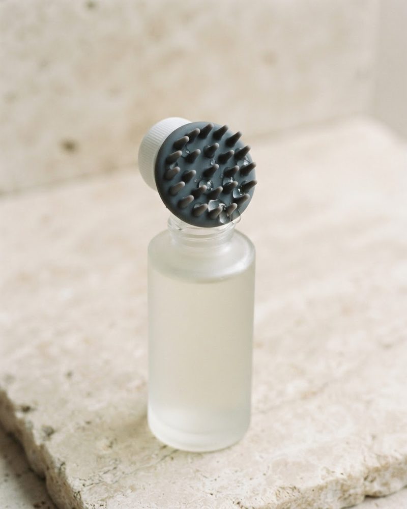 Scalp tonic bottle with a silicone massage applicator