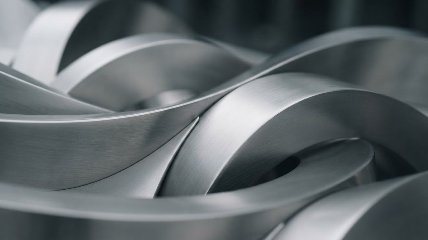 Polished stainless steel surfaces reflecting clean light, representing cosmetics manufacturing quality