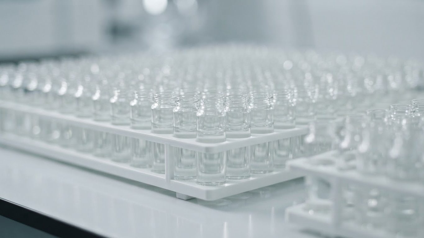 Rows of clear glass vials in a rack